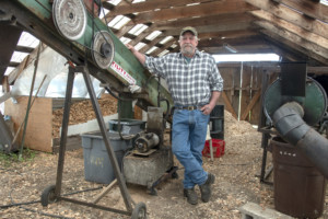 Roger Pion stands next to a pyrolysis machine — or kiln — used to make biochar. Two years into production, Green State Biochar is one of a handful of regional producers bench testing applications and effectiveness in the northeast. 