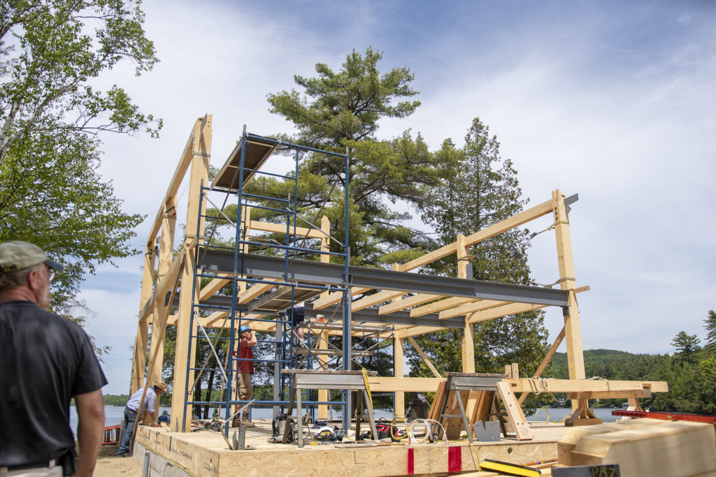 Andy Harper, left, of Winterwood Timber Frames, oversees his crew as they build Randy Kay’s house on Lake Iroquois in Hinesburg.