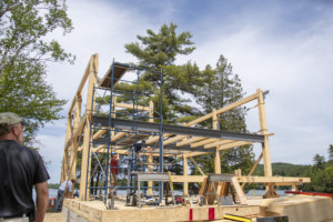 Andy Harper, left, of Winterwood Timber Frames, oversees his crew as they build Randy Hay’s house on Lake Iroquois in Hinesburg.