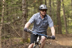Forester Matt Langlais mountain bikes in a Vermont forest pre-COVID-19. Photo by Erica Houskeeper.