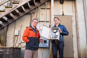 AJ Rossman, left, and Tim Guiterman, stand outside of Rossman’s building in Burlington, Vermont. Rossman used Infisense sensors to monitor air quality of his building during COVID-19. The sensors collect data on temperature, humidity, and occupancy, and send alerts when a room is empty and ready to be cleaned. Photo by Erica Houskeeper.