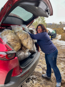 Katie Sullivan packs her vehicle full of wool to be turned into yarn for Bobolink Yarns.