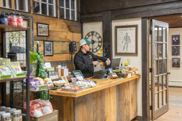 Leslie Garziano scans products at Vermont Hempicurean in West Brattleboro. Photo by Erica Houskeeper.