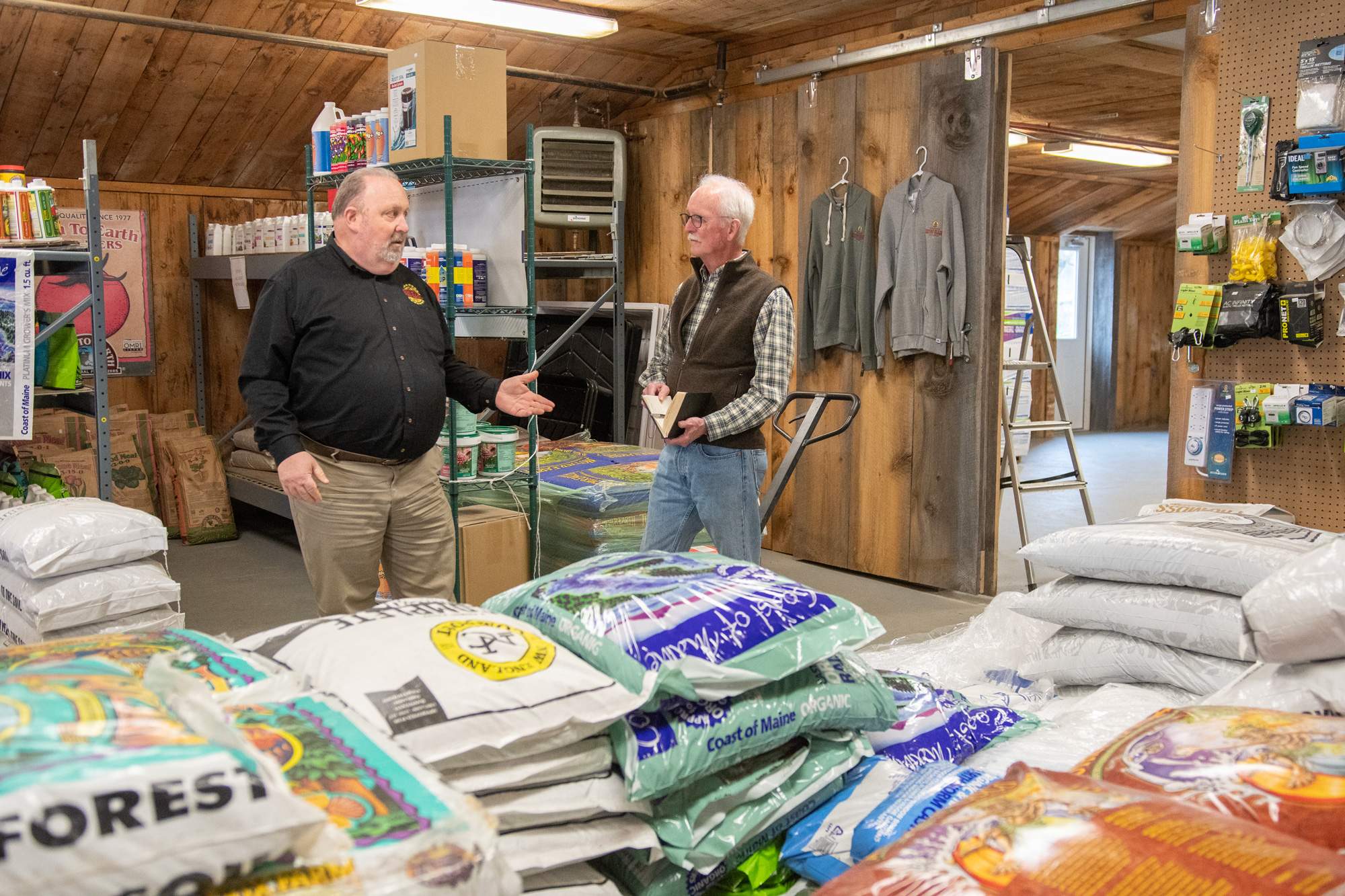 Scott Sparks, left, speaks with Vermont Sustainable Jobs Fund coach Victor Morrison in the Vermont Grow Barn. Photo by Erica Houskeeper.