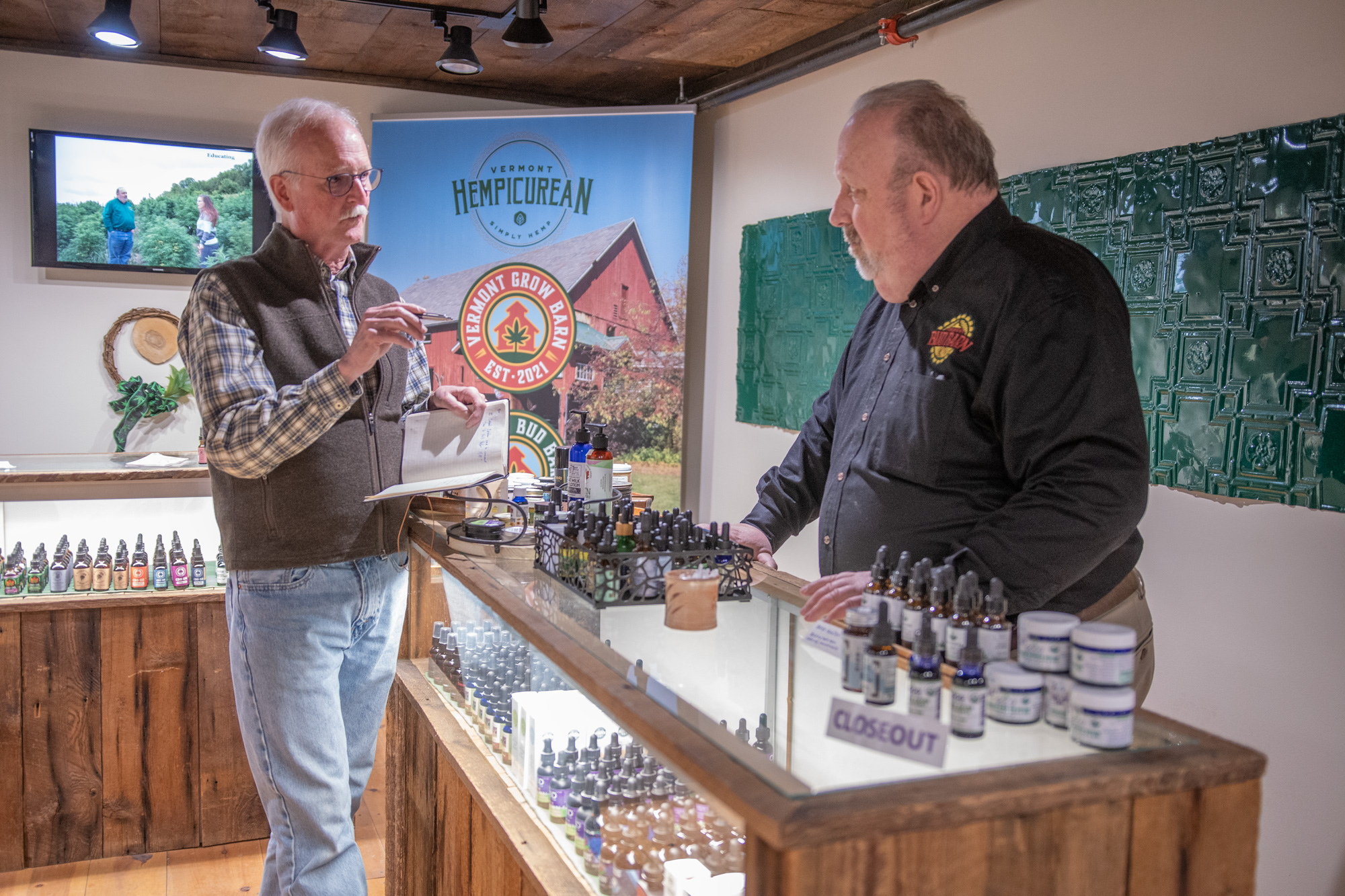 Vermont Sustainable Jobs Fund business coach Victor Morrison, left, consults Scott Sparks on a recent visit to Vermont Hempicurean in West Brattleboro. Photo by Erica Houskeeper.