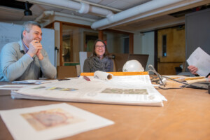 Adam Kane, executive director of the Fairbanks Museum & Planetarium in a meeting with Megan Nedzinski of Vermont Integrated Architecture, which designed the addition. Photo by Erica Houskeeper.