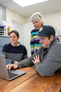 Vermont Sustainable Jobs Fund business coach Jean Kissner, center, reviews business projections with Julie Morton and Erika Lynch. Photo by Erica Houskeeper.