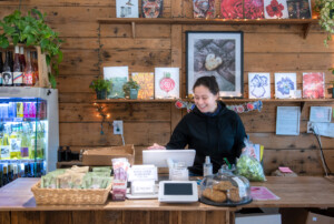 Suzanne Hassanein rings up produce at The Roots Farm Market in Middlesex. Photo by Erica Houskeeper.