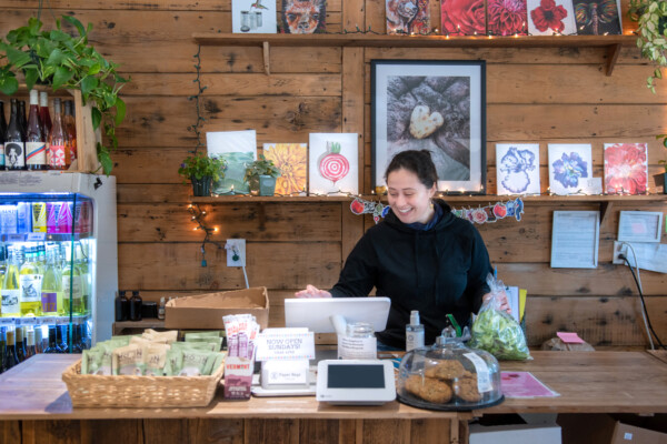 Suzanne Hassanein rings up produce at The Roots Farm Market in Middlesex. Photo by Erica Houskeeper.