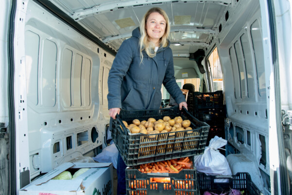 Karin Bellemare unloads a delivery of potatoes at The Roots Farm Market in Middlesex. Photo by Erica Houskeeper.