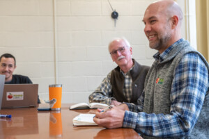Richard Berkfield, executive director of Food Connects, right, at a staff meeting in April. Photo by Erica Houskeeper.