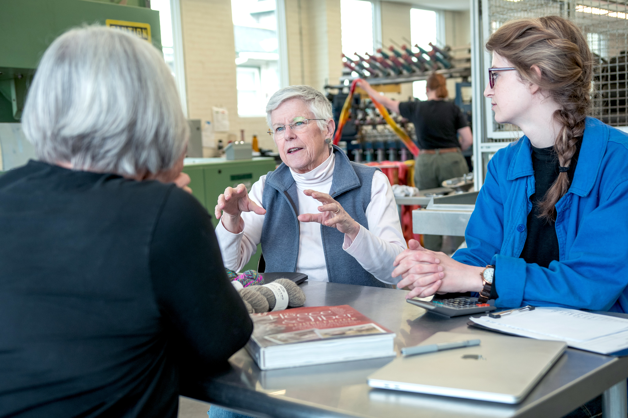 Amanda Kievet and Peggy Allen meet with business coach Carolyn Cooke, right, at Junction Fiber in White River Junction. Photo by Erica Houskeeper.