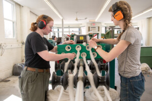 Emma Percy, left and Amanda Kievet prepare to make tracks of yarn at Junction Fiber in White River Junction. Photo by Erica Houskeeper.