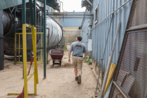 Phil Gervias walks around the Vermont Natural Forest Products property in Richford. Photo by Erica Houskeeper.