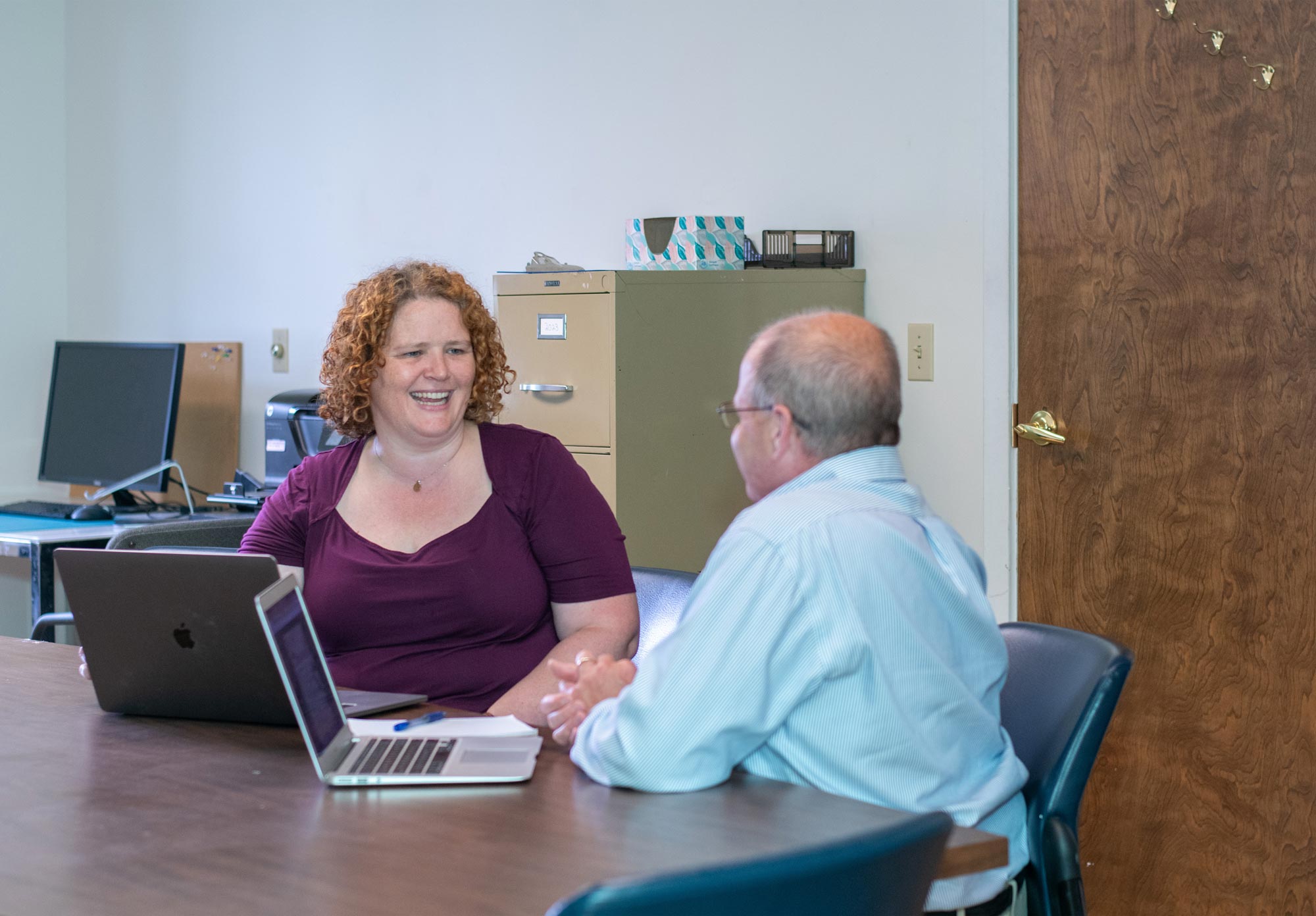 Claire Georges, owner of Butterfly Bakery in Barre, meets with business coach Lawrence Miller. Butterfly Bakery produces its signature hot sauces along with other branded hot sauces and specialty foods. Photo by Erica Houskeeper.