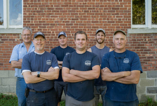 Monument Farms Dairy’s third and fourth generation, front row, left to right: Jon Rooney, Ben James and Bob James. Second row, left to right: Pete James, Dan James and Tyler James. The farm is home to 600 Holstein cows and 560 youngstock, is a quarter mile down the road from the family’s processing and packaging plant. Photo by Erica Houskeeper.