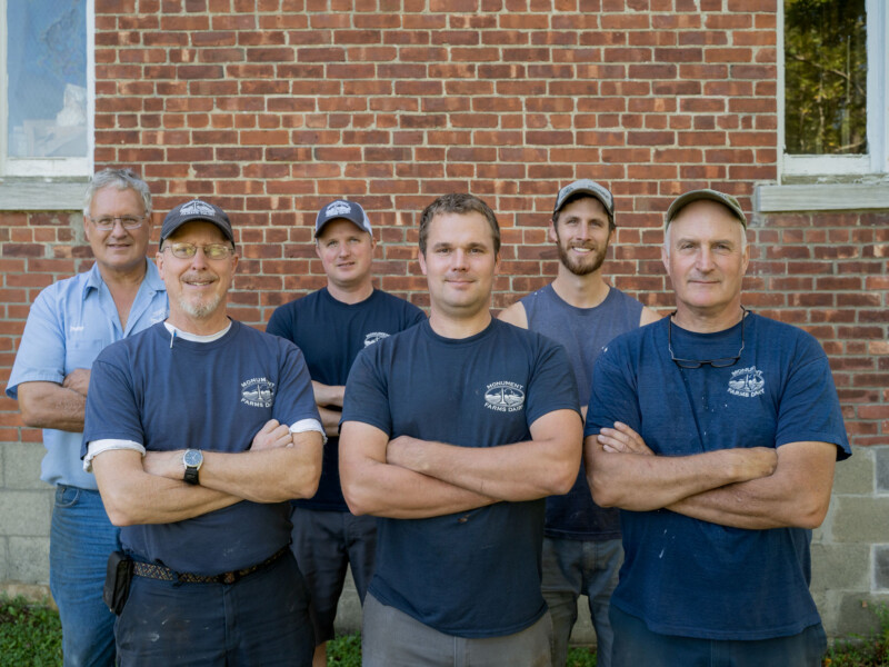 Monument Farms Dairy’s third and fourth generation, front row, left to right: Jon Rooney, Ben James and Bob James. Second row, left to right: Pete James, Dan James and Tyler James. The farm is home to 600 Holstein cows and 560 youngstock, is a quarter mile down the road from the family’s processing and packaging plant. Photo by Erica Houskeeper.