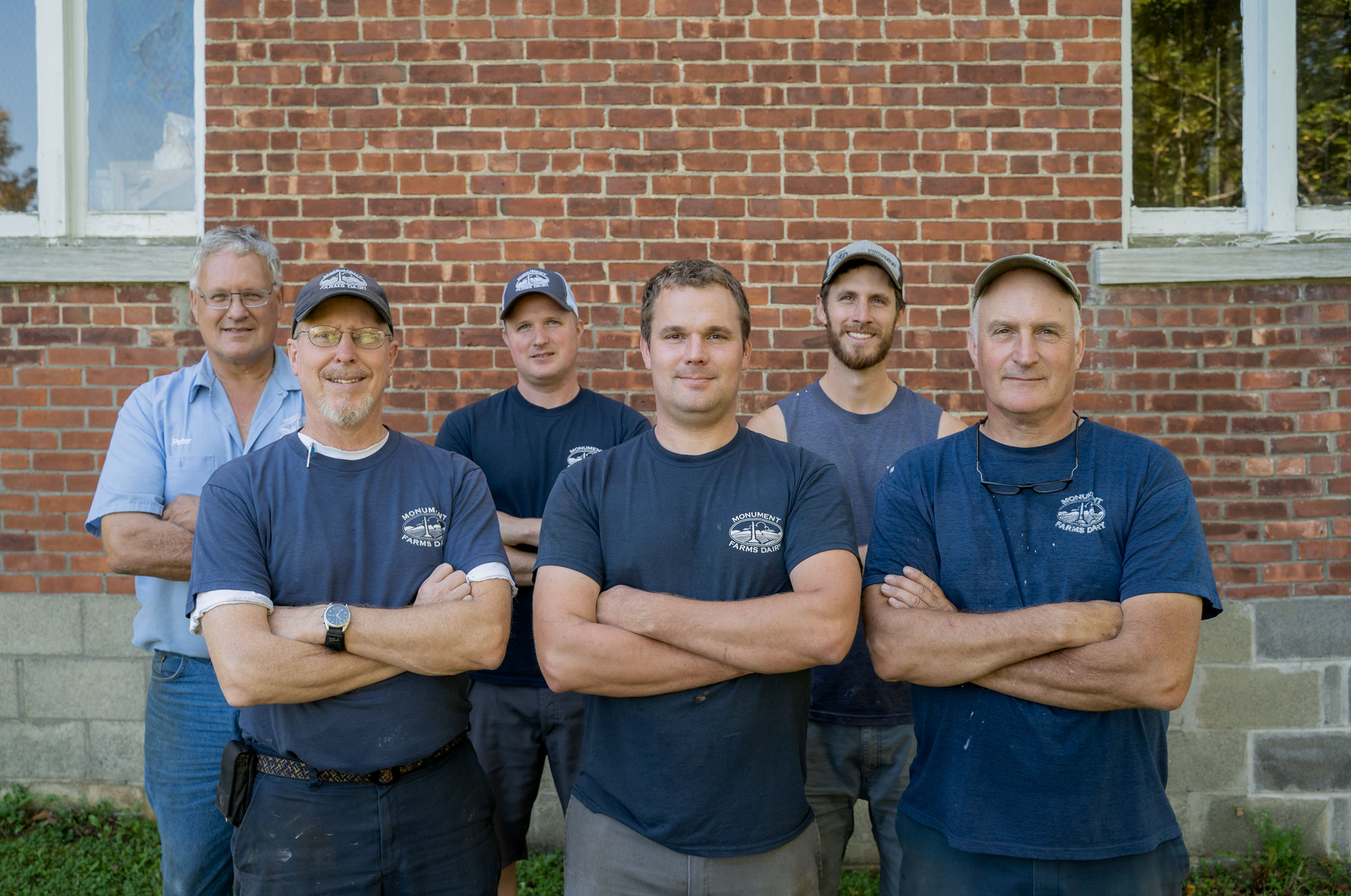 Monument Farms Dairy’s third and fourth generation, front row, left to right: Jon Rooney, Ben James and Bob James. Second row, left to right: Pete James, Dan James and Tyler James. The farm is home to 600 Holstein cows and 560 youngstock, is a quarter mile down the road from the family’s processing and packaging plant. Photo by Erica Houskeeper.