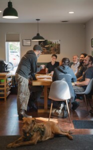 Employee Jacob Deva Racusin presents at an employee meeting at New Frameworks in Essex Junction. As a worker-owned cooperative, the company has taken a people-first approach from day one. Photo by Erica Houskeeper.