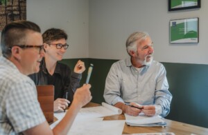 New Frameworks co-founder Julie Krouse, center, meets with VSJF Business Coach Peter Cole, right, and co-founder Ace McArleton. Photo by Erica Houskeeper.