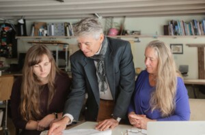 Luella Strattner, Joseph Cincotta, and Julie Lineberger review plans in Wilmington. Photo by Erica Houskeeper.