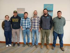 The 2026 cohort of Tools of the Trade – Business Coaching for Energy Pros gathered for a recent work session in Waterbury, VT. From left to right: Sarah and Will Reed of Vermont Foam Insulation, Eric Solsaa of Solsaa Building and Energy Solutions, Martin Bean of Earthshare Construction, Stephen Perkins of Peak Efficiency, and Steven Gruner of Gruner Builders. Not pictured: Colin Doolittle of On the Dot HVAC, and Adam and Tara Lang of Lang Air Conditioning and Refrigeration. Photo courtesy of Vermont Sustainable Jobs Fund.