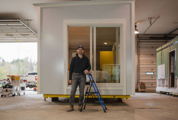 Michael Zembrowski of Up End This standing in front of one of the company’s Satellites, a modular home system designed to meet the evolving needs of modern living. Photo by Erica Houskeeper.